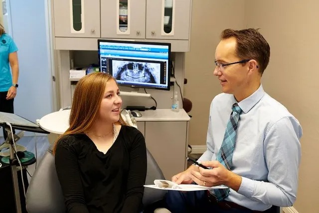 Dr. Matheson reviewing treatment with a patient at Bellissimo Dentistry
